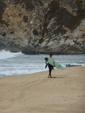 Surfer at Gray Whale Cove State Beach